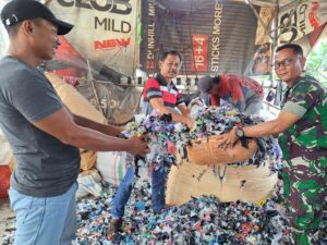 Babinsa Desa Juwiran Serda Tri Doyo dan Kades Juwiran Santosa AMK menunjukkan sampah plastik yang sudah proses giling.